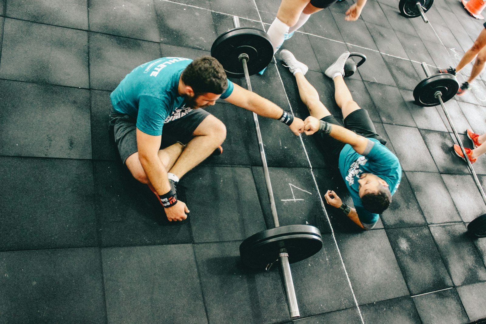 A coach reviewing a training plan one-on-one with a client in a gym